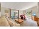 Inviting living area with natural light, plush seating, access to the porch, and a television at 741 Royal Palm Ave, Lady Lake, FL 32159