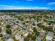 High aerial shot of a neighborhood with neat homes, golf course, and serene lakes, highlighting its desirable location at 8069 Se 174Th Ludlow Pl, The Villages, FL 32162