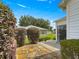 Backyard patio area, accessible through sliding doors, showcasing the well-maintained landscaping at 8069 Se 174Th Ludlow Pl, The Villages, FL 32162