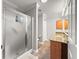 Bathroom showcases a glass door shower and a wood vanity with granite counters at 8069 Se 174Th Ludlow Pl, The Villages, FL 32162