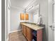 Bathroom features a wood vanity with granite counters and wooden cabinets and drawers at 8069 Se 174Th Ludlow Pl, The Villages, FL 32162