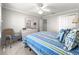 Bedroom showcases neutral walls with a blue and yellow bed and a carpet floor at 8069 Se 174Th Ludlow Pl, The Villages, FL 32162