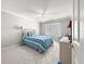 Cozy bedroom with carpet floors featuring a ceiling fan and window at 8069 Se 174Th Ludlow Pl, The Villages, FL 32162