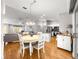 Open concept dining room and kitchen with stainless steel appliances and a hardwood floor at 8069 Se 174Th Ludlow Pl, The Villages, FL 32162