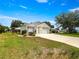A single Gathering home showcasing the multi-car garage and well-kept yard at 8069 Se 174Th Ludlow Pl, The Villages, FL 32162