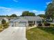 Charming home featuring a multi-car garage, inviting lawn and shrubbery at 8069 Se 174Th Ludlow Pl, The Villages, FL 32162