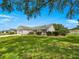 A charming home featuring a multi-car garage, inviting lawn and shrubbery at 8069 Se 174Th Ludlow Pl, The Villages, FL 32162