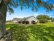 A home featuring a well-kept yard and manicured shrubbery at 8069 Se 174Th Ludlow Pl, The Villages, FL 32162