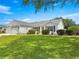 Charming single-story home with well-maintained lawn and manicured shrubbery at 8069 Se 174Th Ludlow Pl, The Villages, FL 32162