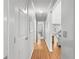 Hallway with wood floors offering views of the living room and a separate bedroom at 8069 Se 174Th Ludlow Pl, The Villages, FL 32162