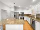 Modern kitchen featuring granite countertops, stainless steel appliances, and wood flooring at 8069 Se 174Th Ludlow Pl, The Villages, FL 32162