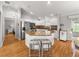 Stylish kitchen featuring an island with seating, stainless steel appliances, and white cabinetry at 8069 Se 174Th Ludlow Pl, The Villages, FL 32162