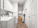 Practical laundry room features a washer, dryer, ample cabinet space, and a clean interior design at 8069 Se 174Th Ludlow Pl, The Villages, FL 32162