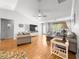 Comfortable living room with ceiling fan, wood floors, and plenty of natural light at 8069 Se 174Th Ludlow Pl, The Villages, FL 32162
