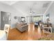 Cozy living room featuring wood floors, modern furniture, and a relaxing atmosphere at 8069 Se 174Th Ludlow Pl, The Villages, FL 32162