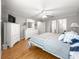 Bright and airy main bedroom with white furniture and ceiling fan at 8069 Se 174Th Ludlow Pl, The Villages, FL 32162