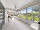 Bright sunroom featuring ceiling fans and large windows offering serene outdoor views at 8069 Se 174Th Ludlow Pl, The Villages, FL 32162