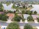 Aerial view of neighborhood featuring beautiful homes, mature trees, and stunning lake views at 8167 Bridgeport Bay Cir, Mount Dora, FL 32757