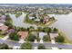Panoramic aerial view of a residential area with houses and winding waterways creating a picturesque community at 8167 Bridgeport Bay Cir, Mount Dora, FL 32757