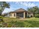 Well maintained backyard with green grass and partial view of home at 8167 Bridgeport Bay Cir, Mount Dora, FL 32757