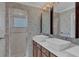 Well-lit bathroom featuring double sinks, a shower stall, and modern fixtures at 8167 Bridgeport Bay Cir, Mount Dora, FL 32757