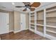 Spacious bedroom featuring hardwood floors and a built in bookshelf at 8167 Bridgeport Bay Cir, Mount Dora, FL 32757