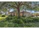 Beautiful home with stone accents, neutral colors, well-manicured lawn, and mature trees at 8167 Bridgeport Bay Cir, Mount Dora, FL 32757