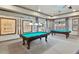 A recreation room featuring two pool tables and nautical-themed decor at 8167 Bridgeport Bay Cir, Mount Dora, FL 32757