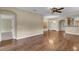 Open living room featuring wood floors, ceiling fan, and seamless transition to other living spaces at 8167 Bridgeport Bay Cir, Mount Dora, FL 32757
