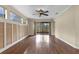 Spacious living area with hardwood floors and natural lighting streaming in from large glass patio doors at 8167 Bridgeport Bay Cir, Mount Dora, FL 32757