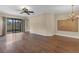 Spacious living room with wood floors, ceiling fan, and sliding doors to the outdoor area at 8167 Bridgeport Bay Cir, Mount Dora, FL 32757