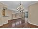 Large living room featuring a chandelier, hardwood floors, and view to the outdoors at 8167 Bridgeport Bay Cir, Mount Dora, FL 32757