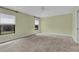 Comfortable bedroom with carpeted floors, natural light, and a serene view of the outdoors at 8167 Bridgeport Bay Cir, Mount Dora, FL 32757
