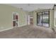 Bright bedroom with access to a bathroom, closet, and outdoor patio through sliding doors at 8167 Bridgeport Bay Cir, Mount Dora, FL 32757