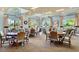 An inviting social room featuring tables and chairs, with large windows providing ample natural light at 8167 Bridgeport Bay Cir, Mount Dora, FL 32757