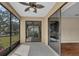 Inviting sunroom with a ceiling fan and sliding glass doors to provide an indoor outdoor living space at 8167 Bridgeport Bay Cir, Mount Dora, FL 32757