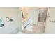 Bathroom featuring a soaking tub, glass-enclosed shower, double vanity, and modern tile flooring at 817 Ocean Course Ave # 502, Davenport, FL 33896