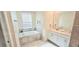 Bright bathroom featuring a tub, double vanity sinks and tile floors at 817 Ocean Course Ave # 502, Davenport, FL 33896