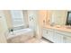 Bathroom showcasing a soaking tub, double sinks, and stylish countertops at 817 Ocean Course Ave # 502, Davenport, FL 33896