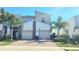Modern two-story home with a paver driveway, two-car garage, and tropical landscaping at 817 Ocean Course Ave # 502, Davenport, FL 33896