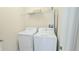 Functional laundry area with a modern washer and dryer, and storage shelf at 817 Ocean Course Ave # 502, Davenport, FL 33896