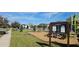 Community playground with swings and slides amid trees and landscaped walkways at 817 Ocean Course Ave # 502, Davenport, FL 33896