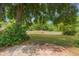 Private backyard space with mature trees, a small bench and lots of room to roam at 8410 Lake Bosse Dr, Orlando, FL 32810