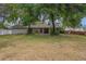 Spacious backyard, ideal for outdoor activities, with mature trees and partial fencing at 8410 Lake Bosse Dr, Orlando, FL 32810