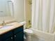 Traditional bathroom features a tub with shower and vanity with a granite countertop at 8410 Lake Bosse Dr, Orlando, FL 32810