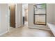 Additional room with a window, bench seating and bathroom access at 8410 Lake Bosse Dr, Orlando, FL 32810