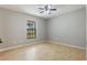Comfortable bedroom featuring a ceiling fan, neutral paint, and ample natural light from the window at 8410 Lake Bosse Dr, Orlando, FL 32810