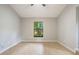 Bright bedroom with a large window offering a peaceful view of the surrounding greenery at 8410 Lake Bosse Dr, Orlando, FL 32810