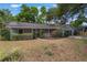 A charming single-story home boasts lush landscaping and a manicured lawn that enhances its curb appeal at 8410 Lake Bosse Dr, Orlando, FL 32810