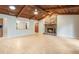 Expansive living area features a brick fireplace, warm wood ceilings, ceiling fan, and access to other rooms at 8410 Lake Bosse Dr, Orlando, FL 32810